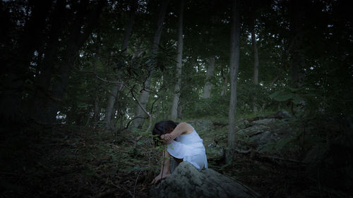 Woman sitting in a forest