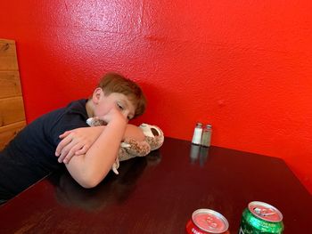 High angle view of boy sitting on table