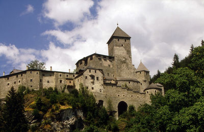 Low angle view of castle against cloudy sky