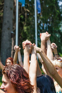Midsection of woman with arms raised