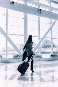 Full length of woman walking at airport