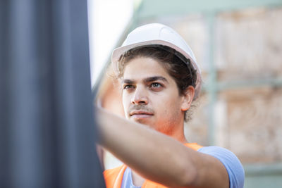 Young construction engineer with helmet working outside