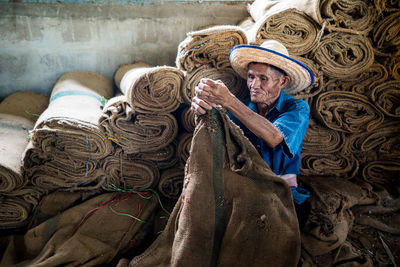 Man folding sacks in workshop