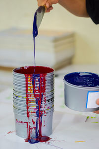 Cropped hand of person mixing paint