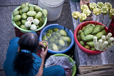 High angle view of woman selling fruits at market