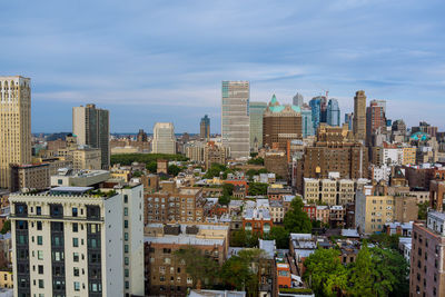 Aerial view of buildings in city against sky