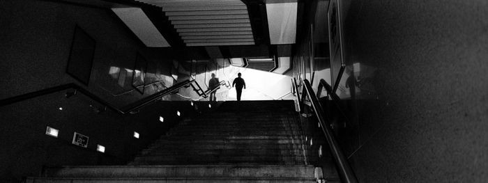 High angle view of people walking on staircase