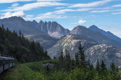 Scenic view of mountains against cloudy sky