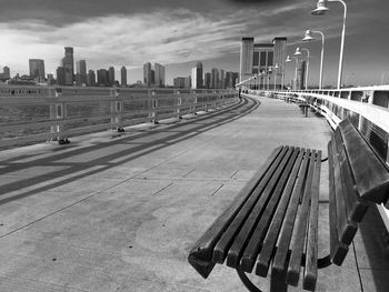 Solitary bench on pier with cityscape in the background  , pier 34 hudson river park, new york 