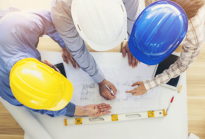 High angle view of people working on table