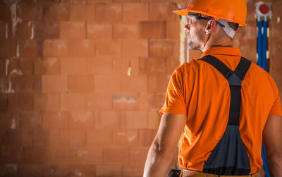 Man working on orange umbrella