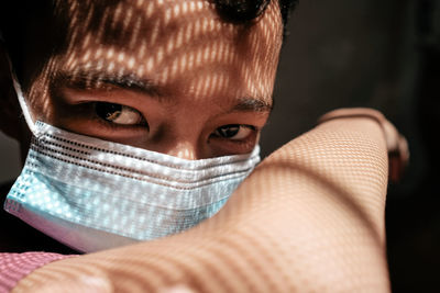 Close-up portrait of woman covering face with hair