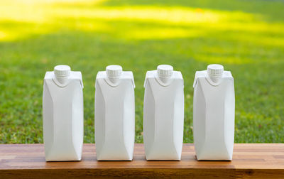 Close-up of white bottles on table