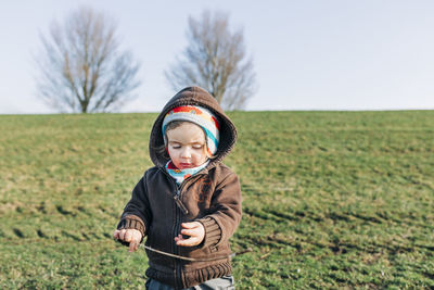 Full length of a boy standing in field