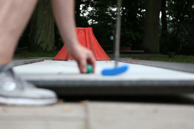 Low section of person playing golf in park