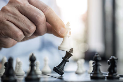 Cropped image of man playing chess at table