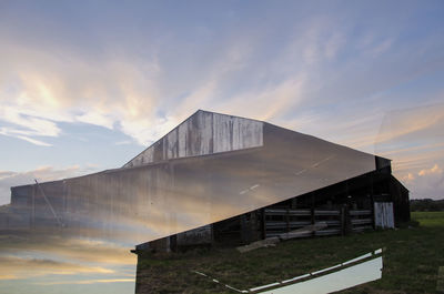 Built structure by water against sky