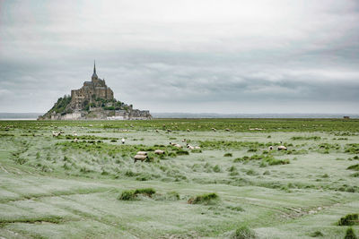 Scenic view of sea by building against sky