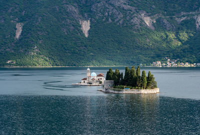 Scenic view of swimming pool by sea against mountain