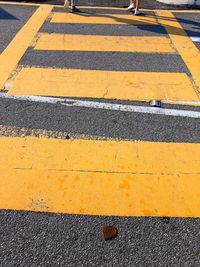 High angle view of yellow crossing sign on road