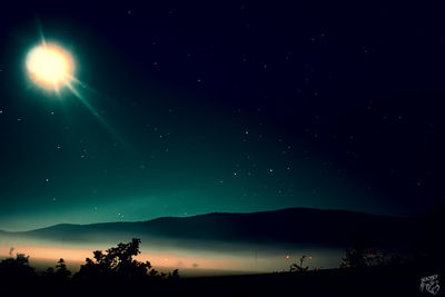 Scenic view of landscape against clear sky at night