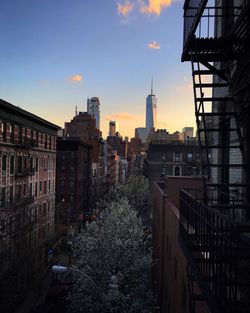 Buildings in city at sunset