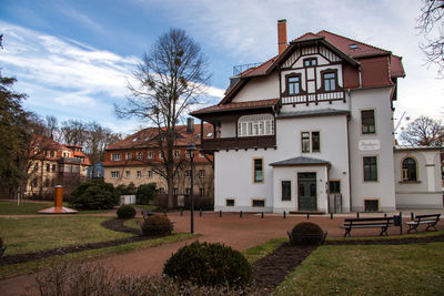 Houses by building against sky in city