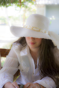 Close-up of young woman wearing hat