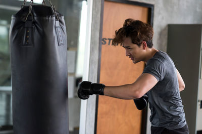 Side view of man exercising in gym