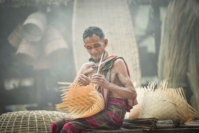 Senior man making wicker basket