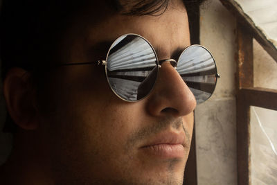 Close-up portrait of man wearing eyeglasses