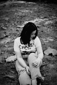 High angle view of woman sitting on field