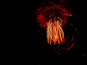 Close-up of illuminated light against black background
