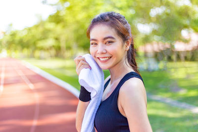 Portrait of smiling young woman using mobile phone