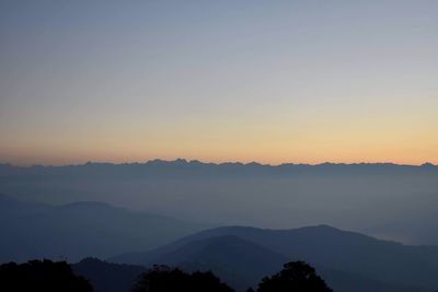 Scenic view of silhouette mountains against sky during sunset