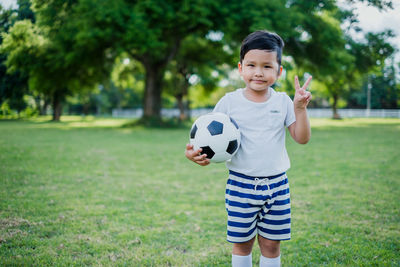 Full length of man holding ball on field