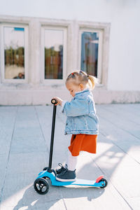 Portrait of boy standing on wheelchair