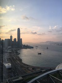 Aerial view of city buildings against sky during sunset