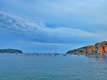 Scenic view of sea against sky in city