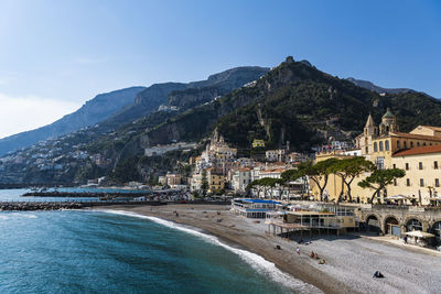 Scenic view of sea by city against sky