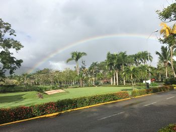 Scenic view of rainbow over road against sky