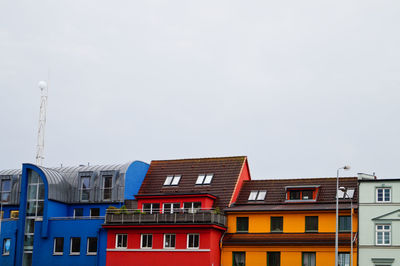 High section of colorful buildings against clear sky