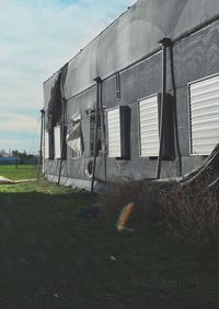 Barn on field against sky