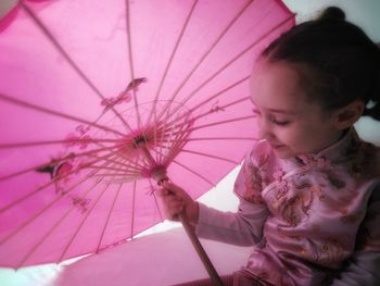 Woman holding pink umbrella