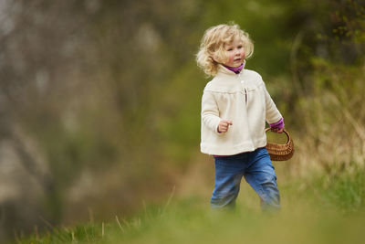 Cute girl standing on field