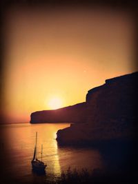 Scenic view of sea against orange sky