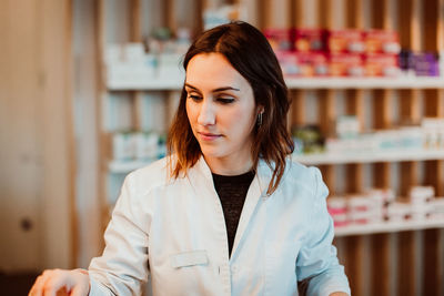 Female pharmacist working at store