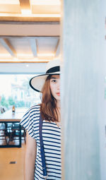 Beautiful young woman standing at home