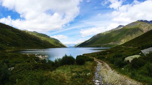 Scenic view of lake and mountains against sky