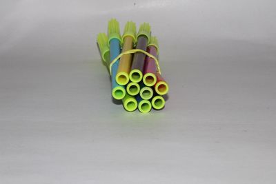 Close-up of multi colored pencils over white background
